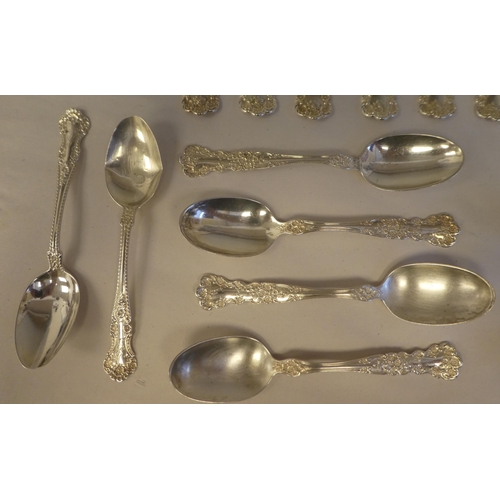 165 - Sterling silver flatware, on decoratively cast floral and scrolled handles, comprising a pair of ser... 