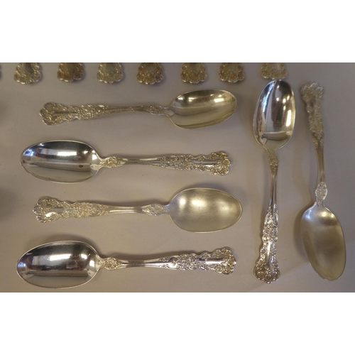 165 - Sterling silver flatware, on decoratively cast floral and scrolled handles, comprising a pair of ser... 