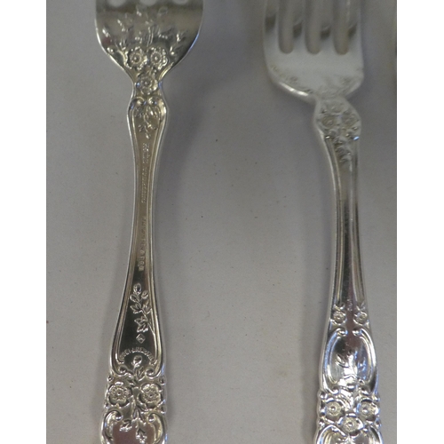 165 - Sterling silver flatware, on decoratively cast floral and scrolled handles, comprising a pair of ser... 