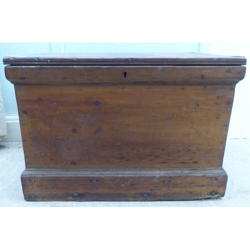 167 - An early 20thC pine chest with a hinged lid  18