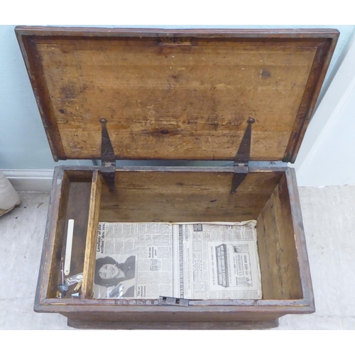 167 - An early 20thC pine chest with a hinged lid  18