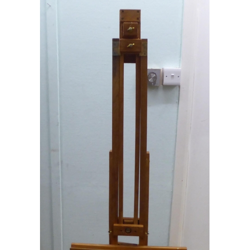 172 - A stained pine and brass mounted folding studio easel 