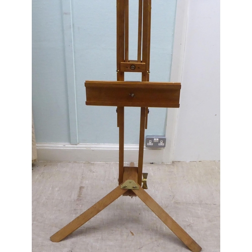 172 - A stained pine and brass mounted folding studio easel 