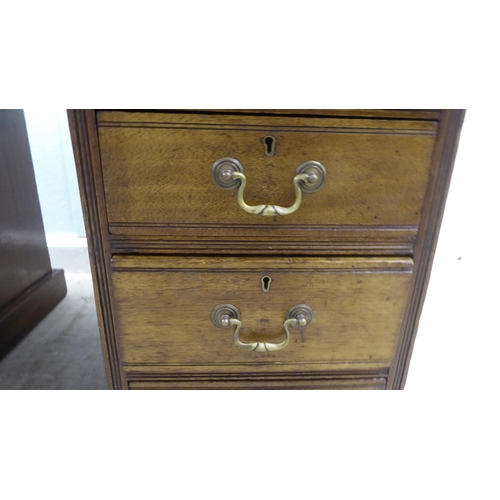 176 - A late Victorian mahogany nine drawer on a twin pedestal desk with a tooled oxblood coloured hide sc... 