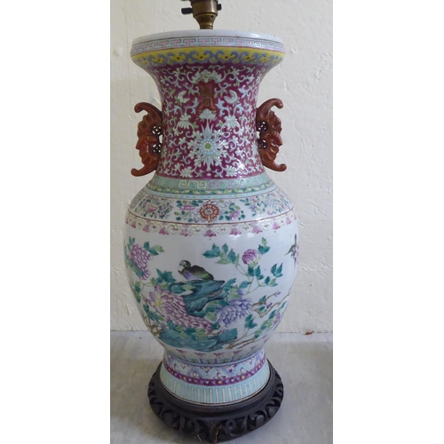 190 - A late 19thC Chinese porcelain table lamp of waisted form, decorated in pastel tones with birds amon... 