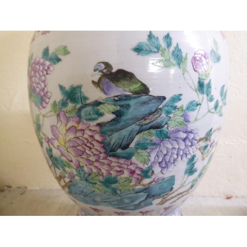 190 - A late 19thC Chinese porcelain table lamp of waisted form, decorated in pastel tones with birds amon... 