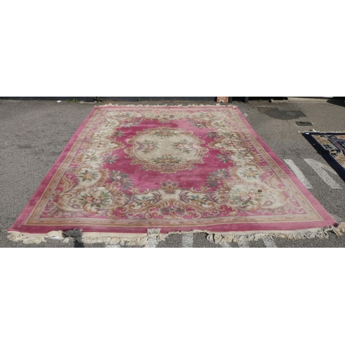 191 - A Chinese washed woollen carpet, decorated with flora in pastel colour, on a pink ground  110