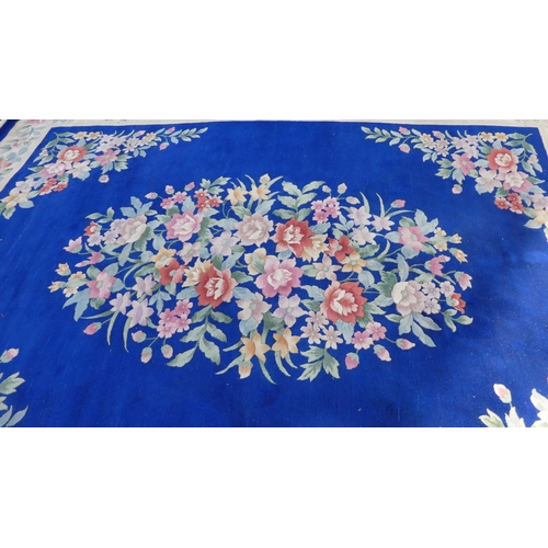 192 - A Chinese washed woollen carpet, decorated with a central floral bouquet motif, bordered by addition... 