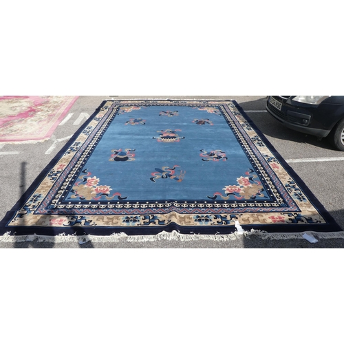 193 - A Chinese washed woollen carpet, decorated with stylised ribbon and floral designs, on a mainly two ... 