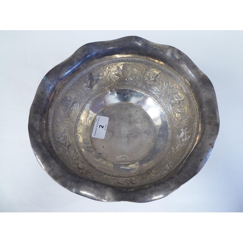 2 - An Asian silver coloured metal bowl with a cut, flared, wavy edged, everted rim, cast and chased wit... 