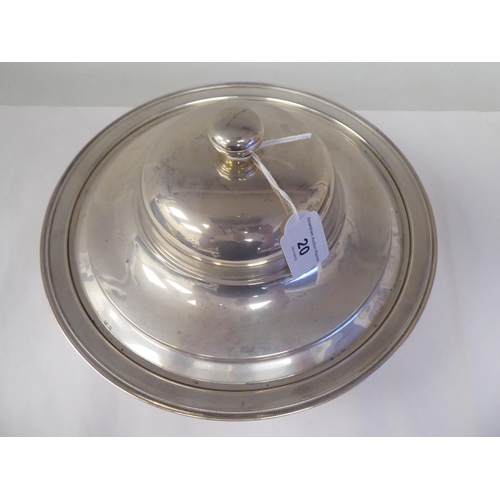 20 - A silver coloured metal serving dish and domed cover with a knop finial  stamped 900  12