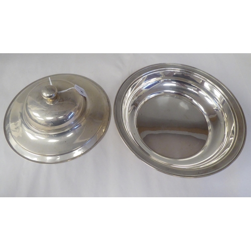 20 - A silver coloured metal serving dish and domed cover with a knop finial  stamped 900  12