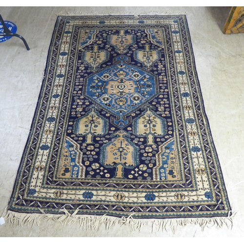 201 - A (possibly Indian) rug, decorated with repeating tree designs, on a multi-coloured ground  62