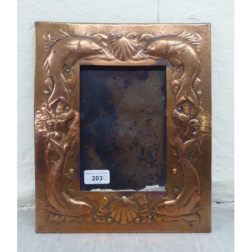 203 - An Arts & Crafts period Newlyn School spot-hammered and pressed copper photograph frame, decorat... 