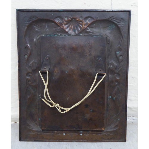 203 - An Arts & Crafts period Newlyn School spot-hammered and pressed copper photograph frame, decorat... 