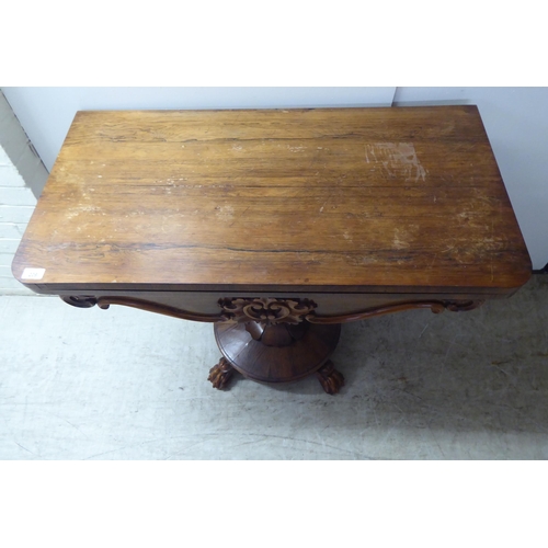 209 - A William IV rosewood card table, the rotating foldover top raised on a bulbous, reeded, pedestal, o... 