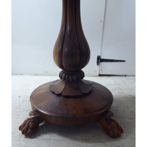 209 - A William IV rosewood card table, the rotating foldover top raised on a bulbous, reeded, pedestal, o... 