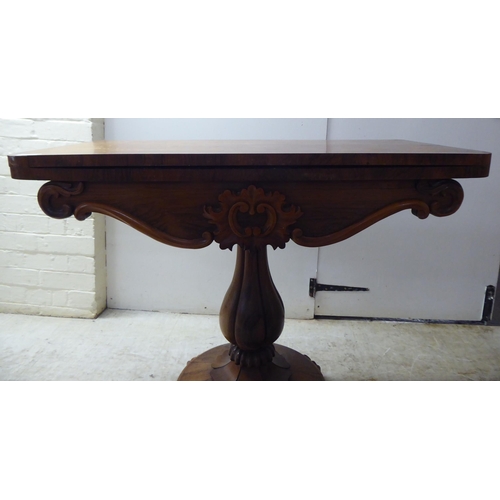 209 - A William IV rosewood card table, the rotating foldover top raised on a bulbous, reeded, pedestal, o... 