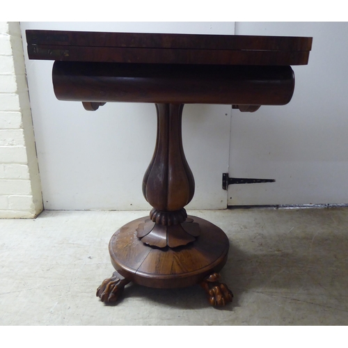 209 - A William IV rosewood card table, the rotating foldover top raised on a bulbous, reeded, pedestal, o... 