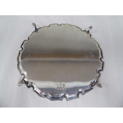 22 - A silver salver with a raised piecrust border, elevated on hoof feet  SB&S  London 192... 