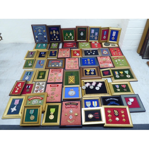 228 - Variously themed replica medals and badges, on presentation fabric backed display boards (Please Not... 