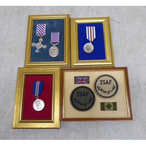 228 - Variously themed replica medals and badges, on presentation fabric backed display boards (Please Not... 