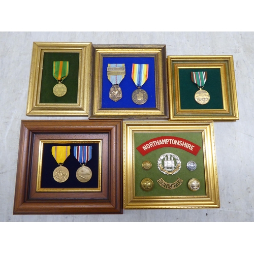 228 - Variously themed replica medals and badges, on presentation fabric backed display boards (Please Not... 