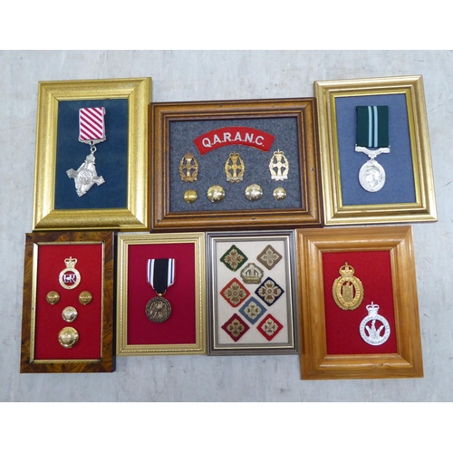 228 - Variously themed replica medals and badges, on presentation fabric backed display boards (Please Not... 