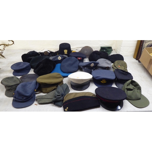 230 - Hats: to include military helmets, peaked caps and berets(Please Note: this lot is subject to the st... 