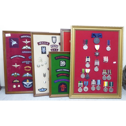 232 - Five framed displays of replica medals and fabric badges (Please Note: this lot is subject to the st... 