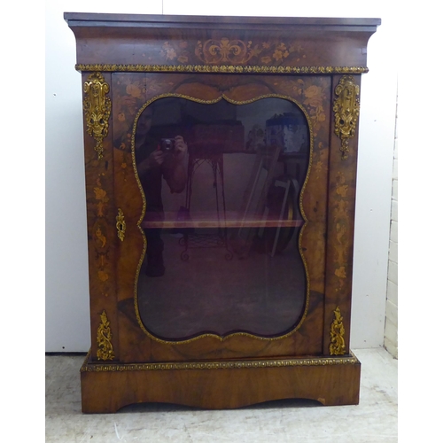 237 - A late Victorian walnut and floral marquetry pier cabinet with ormolu gilt mounts, the glazed door e... 