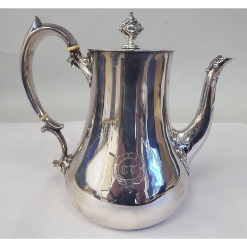 25 - A mid Victorian silver pear shape coffee pot, double C-scrolled handle and a flush fitting hinged li... 