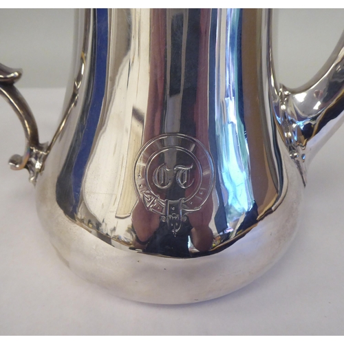 25 - A mid Victorian silver pear shape coffee pot, double C-scrolled handle and a flush fitting hinged li... 