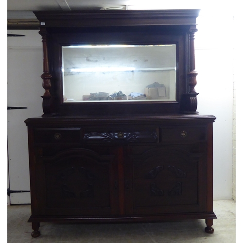 250 - A modern reproduction of a Victorian mahogany dresser, the superstructure with a bevelled mirror pan... 