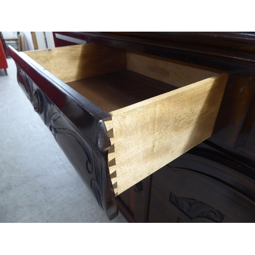 250 - A modern reproduction of a Victorian mahogany dresser, the superstructure with a bevelled mirror pan... 