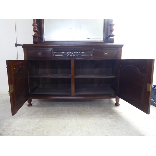 250 - A modern reproduction of a Victorian mahogany dresser, the superstructure with a bevelled mirror pan... 