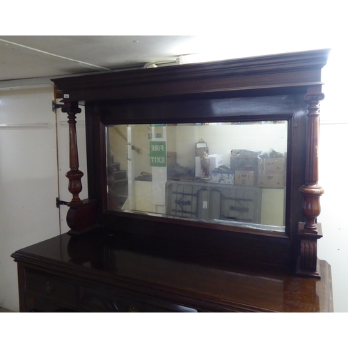 250 - A modern reproduction of a Victorian mahogany dresser, the superstructure with a bevelled mirror pan... 