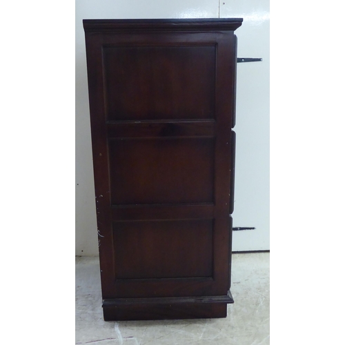 253 - A modern mahogany three drawer filing cabinet, on a plinth  45