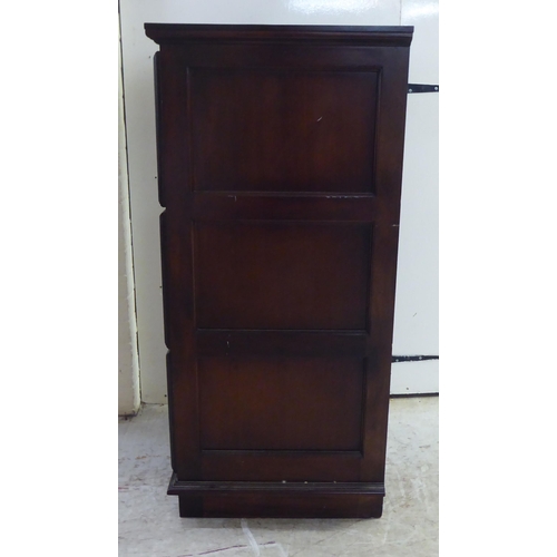 253 - A modern mahogany three drawer filing cabinet, on a plinth  45