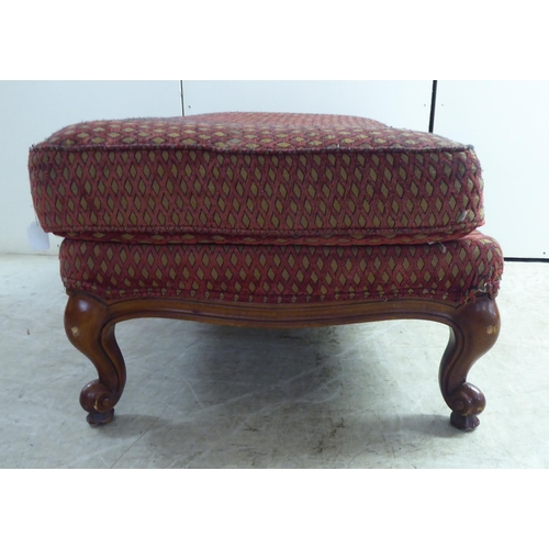 256 - A modern diamond formation pattern fabric upholstered footstool, raised on cabriole legs 