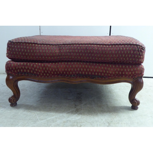 256 - A modern diamond formation pattern fabric upholstered footstool, raised on cabriole legs 