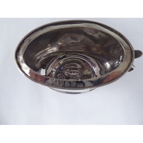 26 - An early 19thC silver oval, bead bordered mustard pot with a hinged, domed lid, thumbpiece, finial a... 