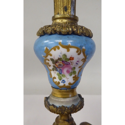 28 - A pair of late 19thC Continental decoratively cast gilt metal and painted porcelain candlesticks wit... 