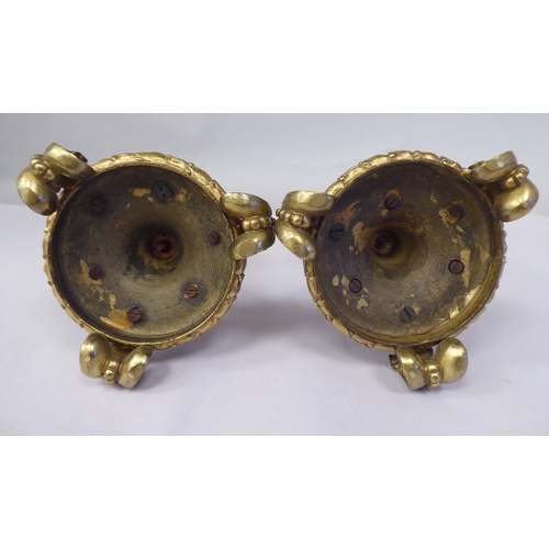 28 - A pair of late 19thC Continental decoratively cast gilt metal and painted porcelain candlesticks wit... 