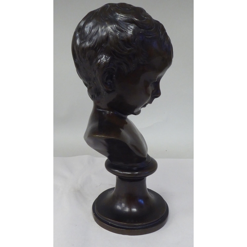 30 - A late 19thC cast and patinated bronze bust, a young boy, on a turned socle  11.5