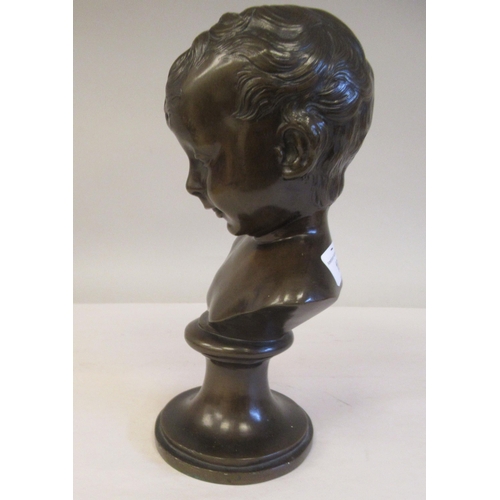 30 - A late 19thC cast and patinated bronze bust, a young boy, on a turned socle  11.5