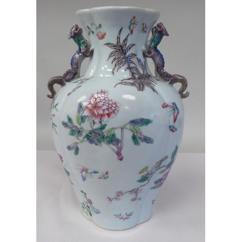 32 - A 20thC Chinese porcelain vase of flattened and panelled baluster form, incorporating opposing, moul... 