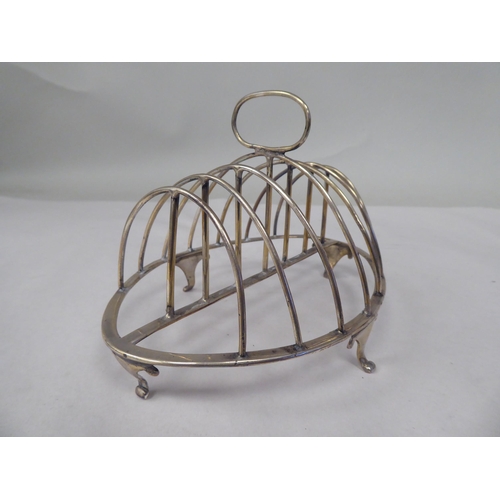 40 - A late George III silver six division toastrack of oval outline with a wire framed superstructure, o... 