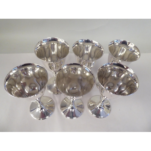 45 - A set of six silver inverted bell design wine goblets, each elevated on a knopped, tapered stem and ... 