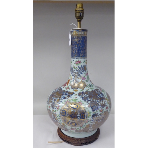 48 - An early 20thC Chinese porcelain bottle vase design table lamp, decorated in colours and gilding wit... 